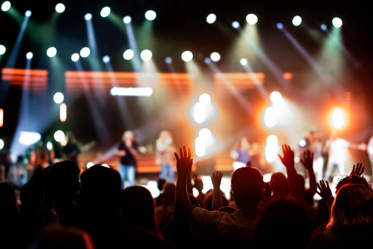 Worshippers with raised hands at a conference